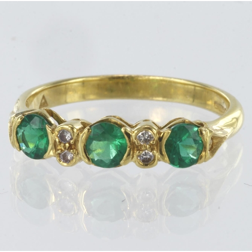 94 - 18ct yellow gold ring set with three round emeralds measuring approx. 3.5mm diameter separated by fo... 