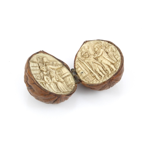 980 - Napoleonic Prisoner of War interest. A walnut split in two and hinged with intricately carved bone d... 