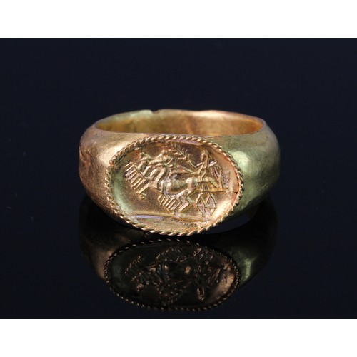 991 - Roman Gold Quadriga Chariot Finger Ring: Comprising a plain hollow hoop expanding to a flat, ellipti... 