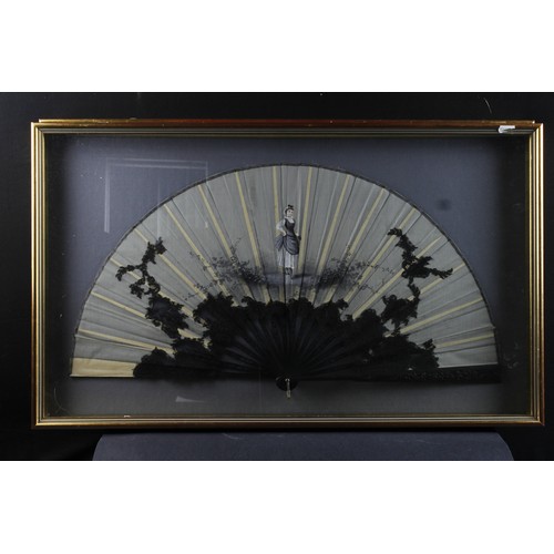 946 - Decorative fans- One black fan decorated with a painted image depicting a woman wearing a bustle ski... 