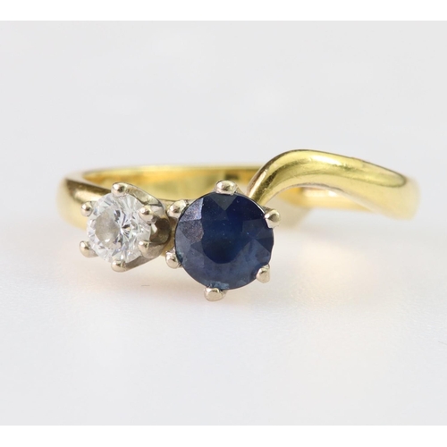 101 - 18ct yellow gold ring set with a round sapphire measuring approx. 5mm diameter and a single round br... 