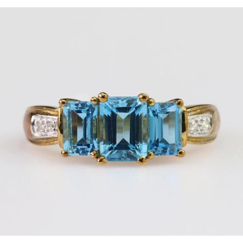 104 - 9ct yellow gold dress ring set with three graduated rectangular step cut blue topaz measuring approx... 