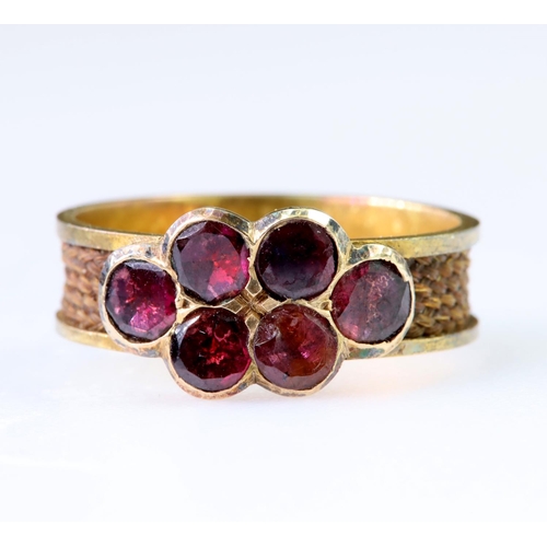 118 - 15ct yellow gold ring set with six faceted almandine garnet slices in rub over settings, on a wide b... 