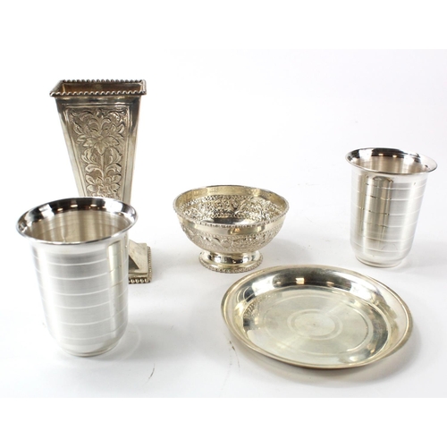 579 - Five white metal items, comprising ornately decorated vase, two beakers, tray and small bowl on pede... 