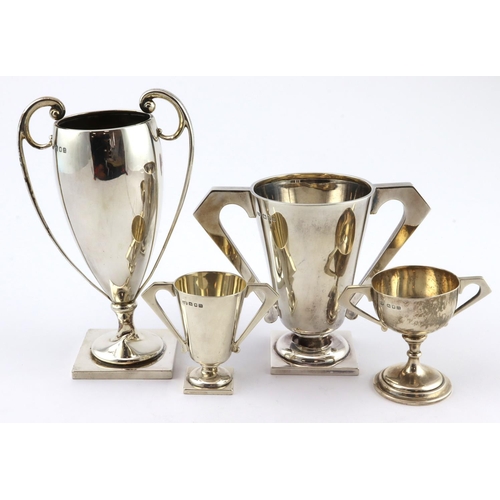 581 - Four silver prize cups with various hallmarks. Various  sizes, the two large ones are a bit damaged ... 