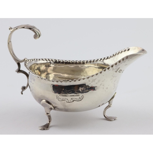 587 - George III silver sauce-boat, very attractive armorial on the side of the item which shows a running... 