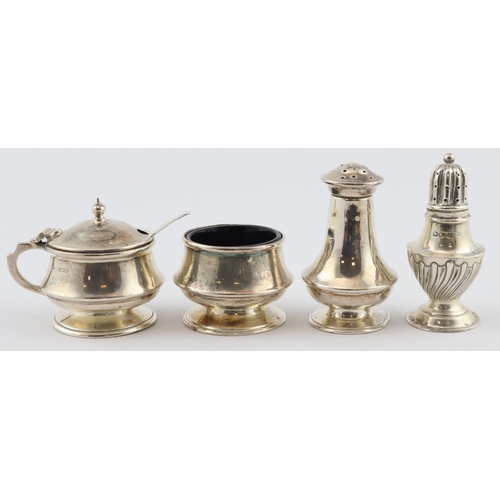 724 - Three piece silver cruet, mustard, pepper & salt with two blue glass liners. Hallmarked JC Ltd., Bir... 