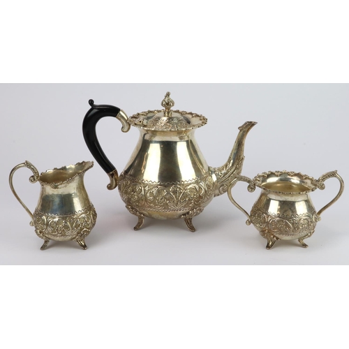 753 - White metal matching teapot, sugar bowl & milk jug, each with ornate decoration, stamped 'Silver' to... 