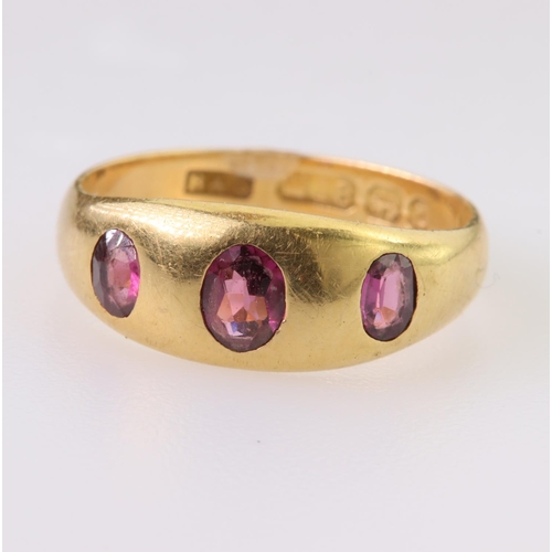 87 - 18ct yellow gold flared head ring set with three graduated oval pink sapphires, finger size K, weigh... 