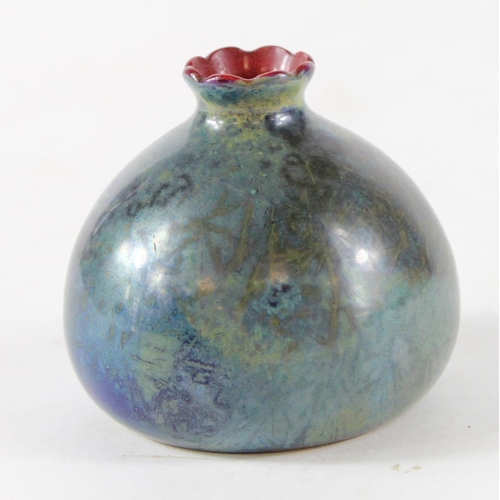 874 - Bernard Moore- A small squat vase in blue/green flambe glaze with red interior. Within the glaze are... 