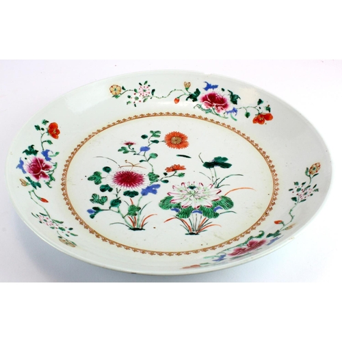 884 - Chinese interest- A famille rose Chinese charger depicting flowers in the centre surrounded by a gil... 