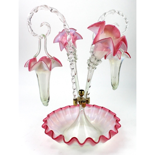 893 - Epergne. A cranberry and milk glass epergne featuring twisted glass hangers complete with two basket... 