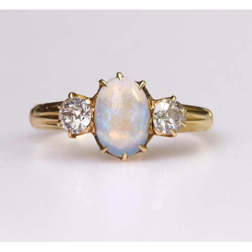 90 - 18ct yellow gold ring set with central oval opal cabochon measuring approx. 9mm x 6mm, with a single... 