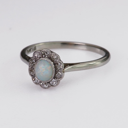 94 - Platinum and 18ct white gold cluster ring set with a cenral oval opal cabochon measuring approx. 5mm... 