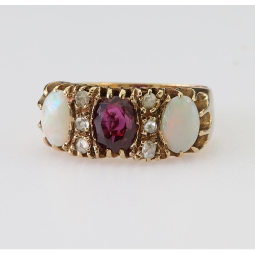 95 - 9ct yellow gold ring set with a central oval pink tourmaline measuring approx. 7mm x 5.5mm and two o... 