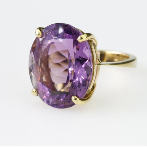 98 - 9ct yellow gold dress ring set with single oval amethyst measuring approx. 17mm x 14mm in a four cla... 