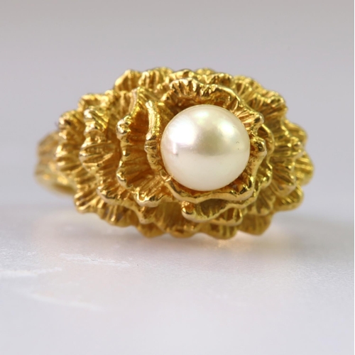 99 - 18ct yellow gold dress ring set with a single cultured pearl mounted on top of four heavily textured... 