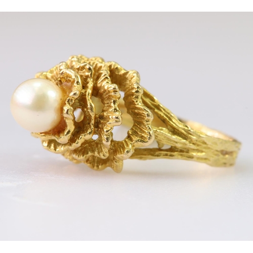 99 - 18ct yellow gold dress ring set with a single cultured pearl mounted on top of four heavily textured... 