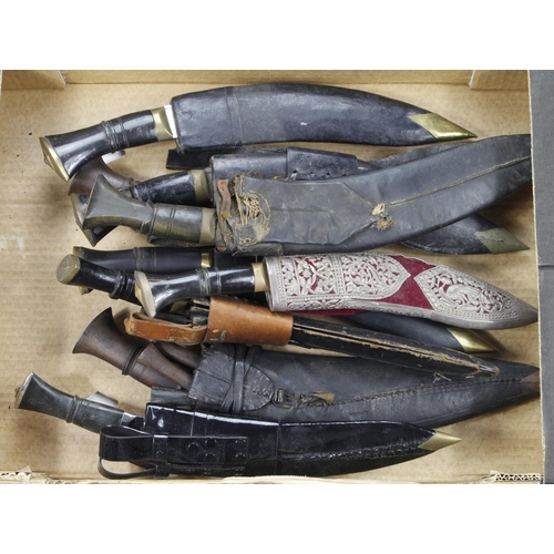 130 - Kukri knives, several various types with scabbards, in a banana box. Two stamped on the blade 1) Dhr... 