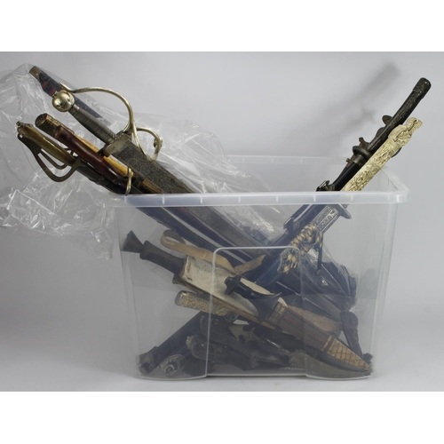 132 - Large plastic crate of various replica Japanese swords, Tulwar and other foreign daggers, etc. (Qty)... 