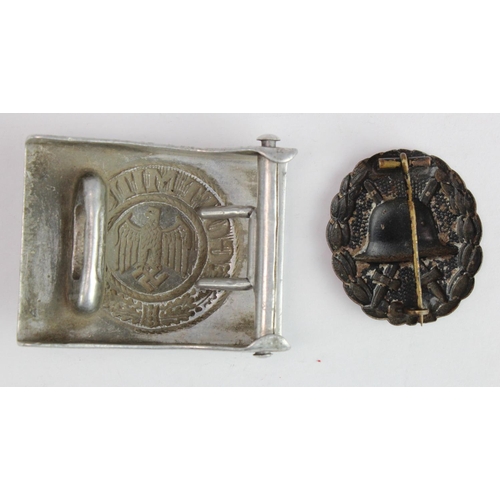 299 - German Nazi Army belt buckle maker marked 'H A 37'. Plus a WW1 Black Wounds Badge. (2)