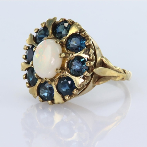 115 - 9ct yellow gold dress ring featuring a central oval opal measuring approx. 9mm x 7mm surrounded by e... 