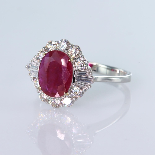 120 - 18ct white gold cluster ring featuring a central oval ruby measuring approx. 9mm x 7mm and weighing ... 