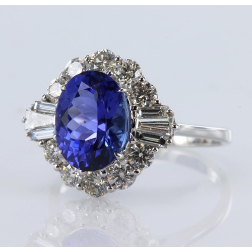 123 - 18ct white gold ring featuring a central oval tanzanite weighing 3.33ct, and surrounded by ten round... 