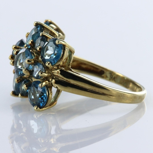 130 - 9ct yellow gold dress ring set with eight round 5mm diameter, and seven 3mm round blue topaz stones.... 