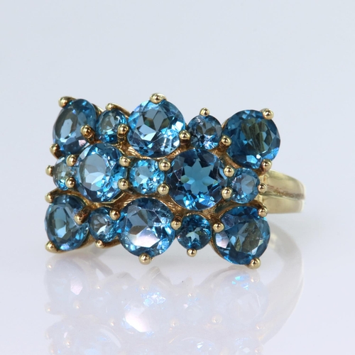 130 - 9ct yellow gold dress ring set with eight round 5mm diameter, and seven 3mm round blue topaz stones.... 