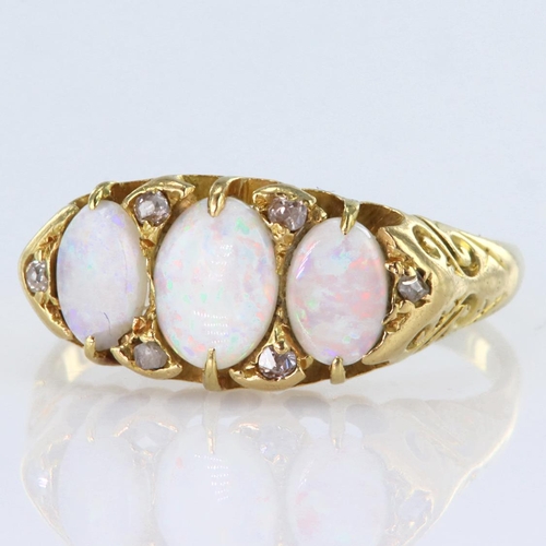 131 - 18ct yellow gold graduated opal three stone ring set in a carved head mount with six diamond highlig... 