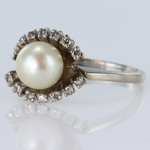 141 - 18ct white gold ring set with a central cultured pearl measuring approx. 7.5mm, either side fans out... 