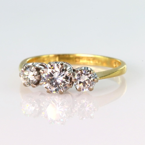 145 - 18ct yellow gold graduated three stone diamond ring, centre diamond weight approx. 0.45ct, with two ... 