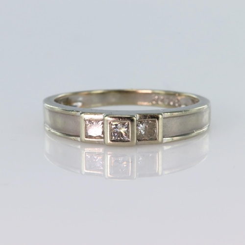 147 - 9ct white gold ring set with three princess cut diamonds in a stepped rub over setting, total diamon... 