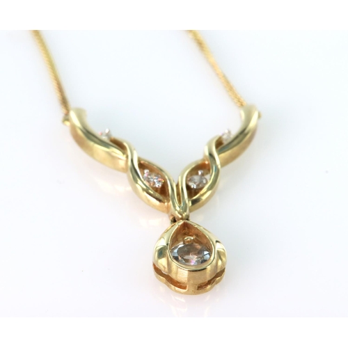 239 - 9ct yellow gold necklace featuring a pear shaped sky blue topaz and highlighted by four round brilli... 