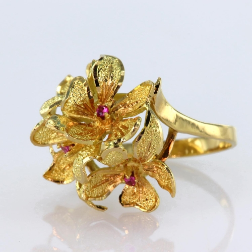 29 - High carat yellow gold dress ring depicting four flowers with ruby centre, finger size N, weight 5.7... 