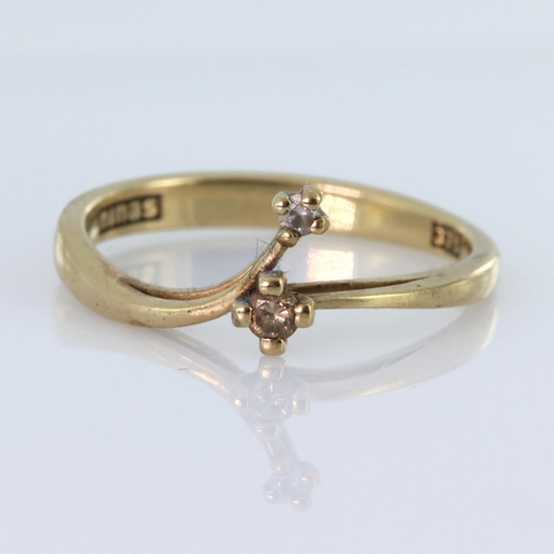3 - 9ct yellow gold band ring set with two round diamonds with a total diamond weight of approx. 0.04ct,... 
