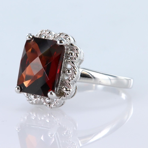 36 - 9ct white gold chequerboard cut garnet measuring appox. 10mm x 7mm, finger size N, weight 3.5g