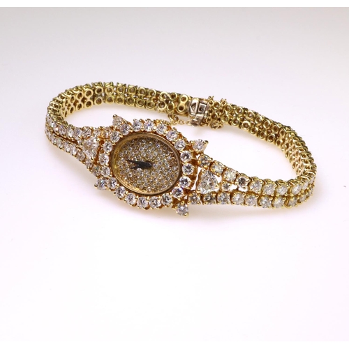 581 - 18ct yellow gold diamond set mechanical wind cocktail watch comprising a two row diamond set bracele... 