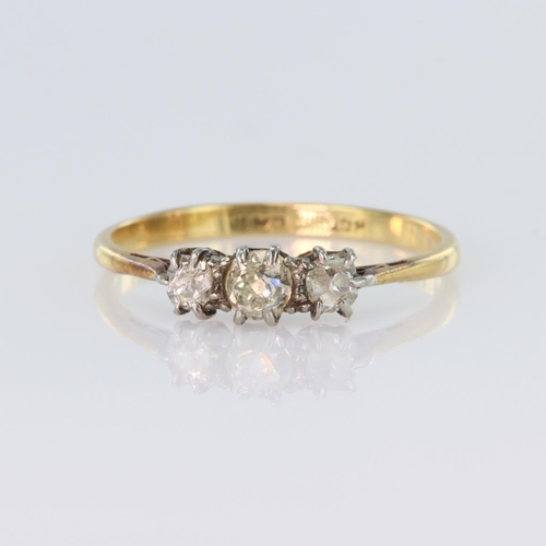 61 - 18ct yellow gold trilogy ring set with three graduated old cut diamonds in claw settings, centre dia... 