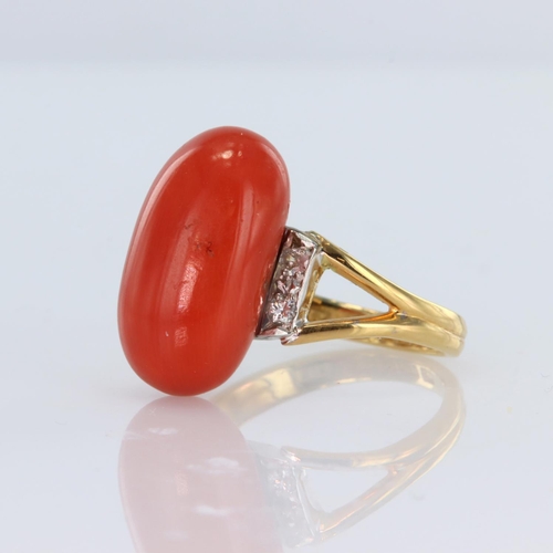 63 - 22ct yellow gold ring set with an elongated bead of coral highlighted by four round old cut diamonds... 