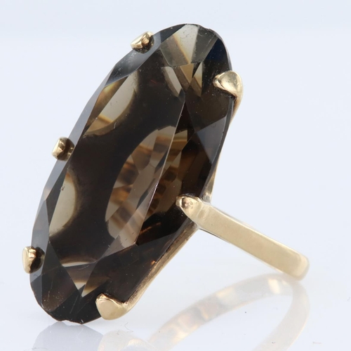 76 - 9ct yellow gold dress ring set with elongated oval smoky quartz measuring approx. 29mm x 15mm, finge... 