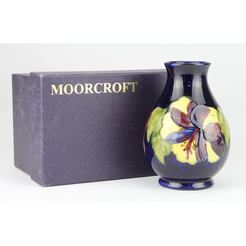 799 - Moorcroft 'Hibiscus' Blue Vase. 1st quality, boxed. Height measures 13cm