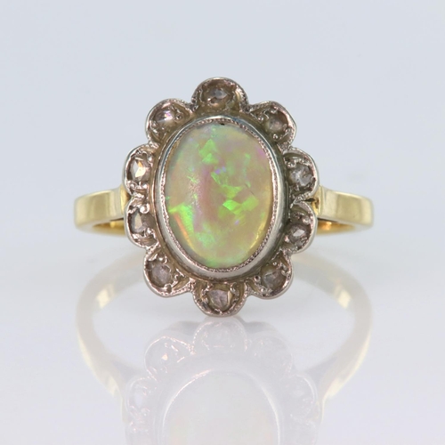 82 - 18ct yellow gold and platinum cluster ring set with a central oval opal cabochon measuring approx. 1... 