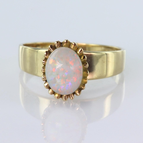 86 - 9ct yellow gold ring set with a single oval opal cabochon measuring approx. 8mm x 6mm set in a high ... 