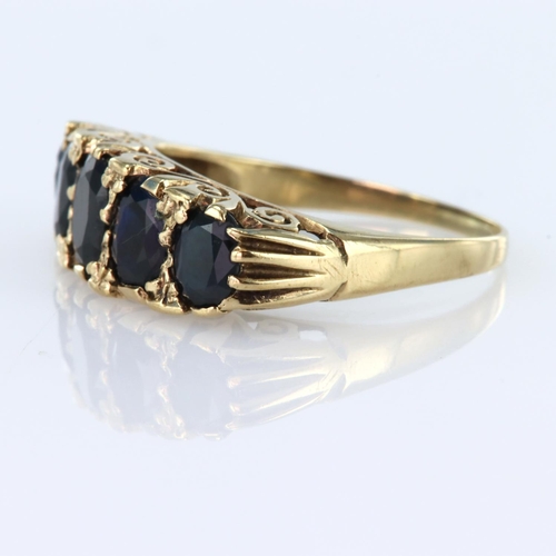 98 - 9ct yellow gold carved head five stone ring set with five graduated size oval sapphires, finger size... 