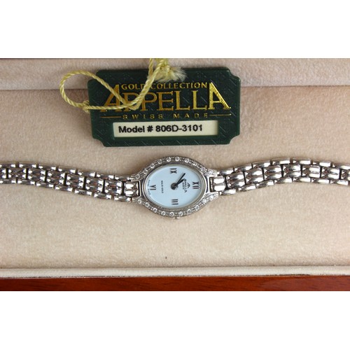 568 - Ladies 18ct white gold quartz wristwatch by Apella. The oval white dial with ten diamonds either sid... 