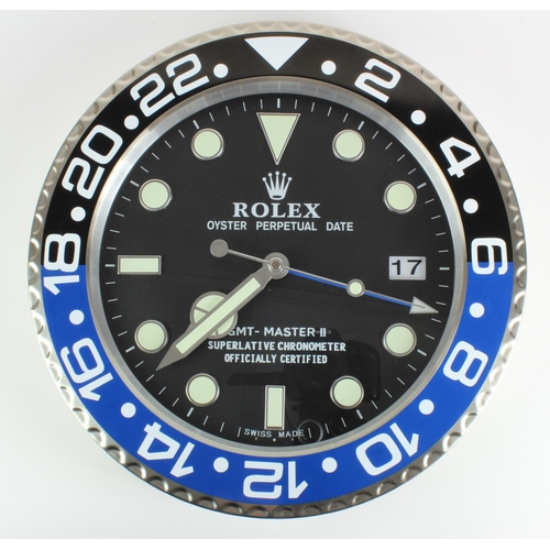 418 - Advertising Wall Clock. Black & blue (Batman) 'Rolex' style advertising wall clock, black dial reads... 