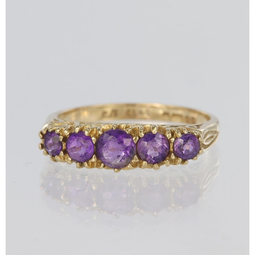 90 - 9ct yellow gold graduated five stone ring set with round purple stones (some chipped) in claw settin... 