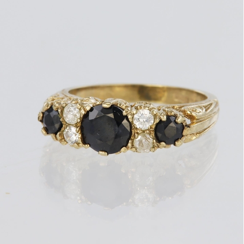 91 - 9ct yellow gold sapphire and paste set seven stone ring, finger size K, weight 3.7g